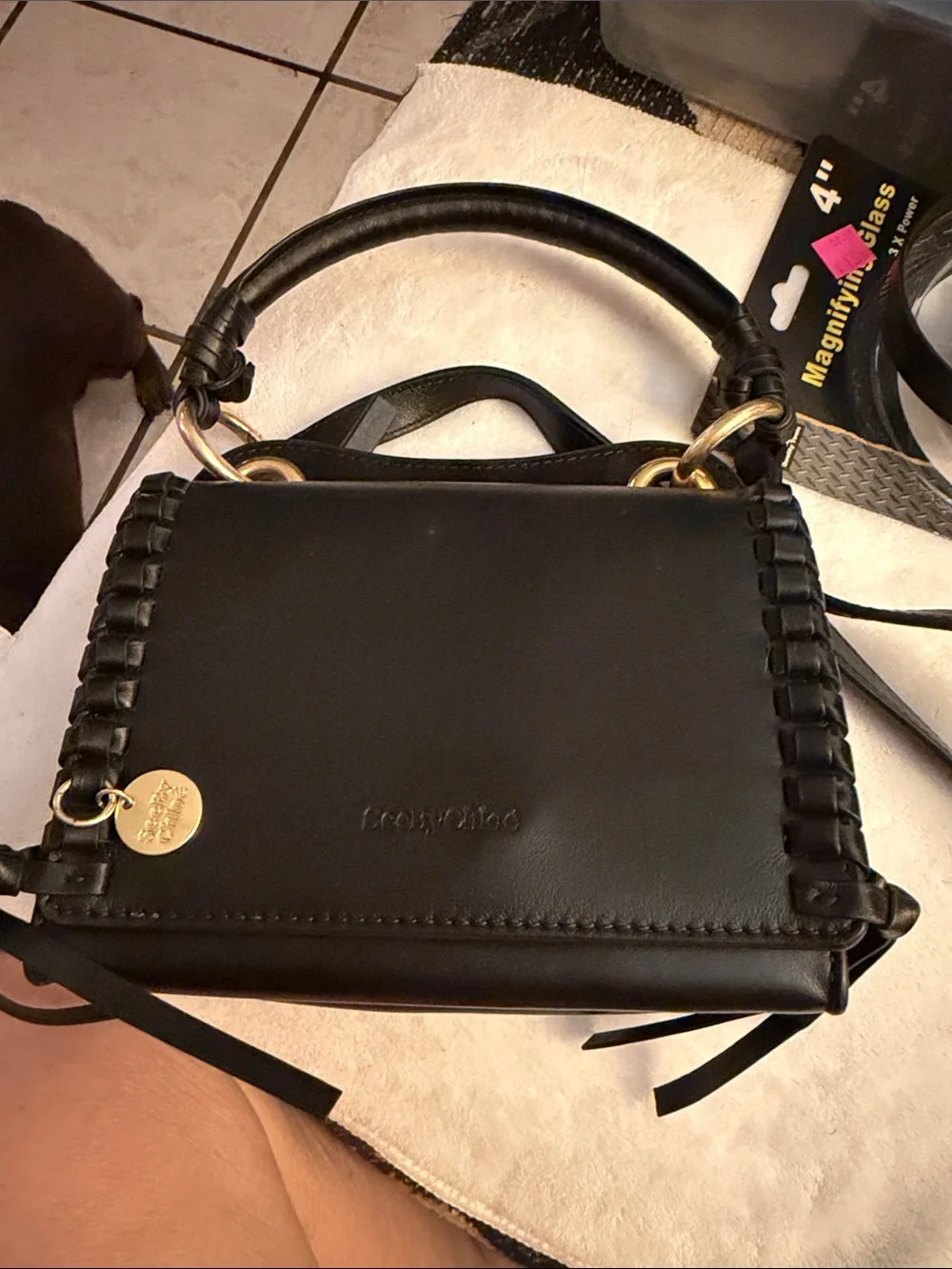 Black Satchel Handbag with Woven Edge and Gold Charm